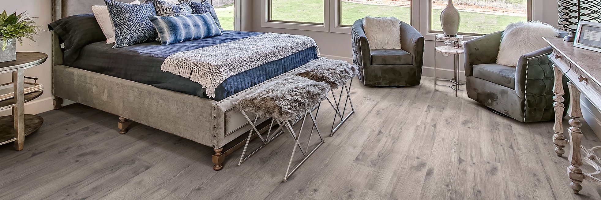 Bedroom with wood-look laminate flooring from Pat Smith’s Flooring in the Louisville, KY area